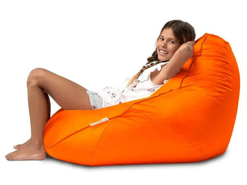 Person sitting on an orange bean bag chair against a white background