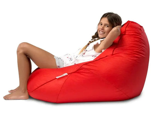 Person sitting on a red bean bag chair against a white background