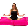 lady doing yoga pose on pink beanbag