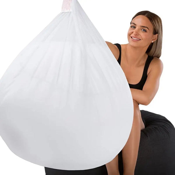Woman peeking out from behind a white bean bag chair with a plain background - Bean Bags R Us — image 1