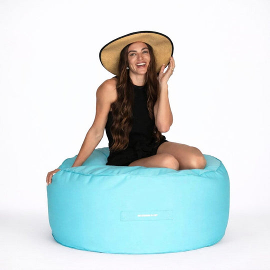 lady posing on a capri blur round outdoor ottoman