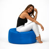 lady sitting on a blue round outdoor ottoman