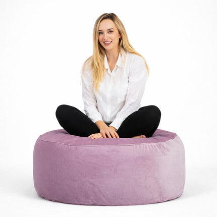 lady sitting on a pale pink velvet ottoman