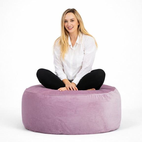lady sitting on a pale pink velvet ottoman