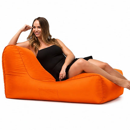 lady posing on a media lounge outdoor bean bag lounger in orange