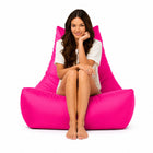 lady posing a bright pink bean bag chair — thumbnail 11