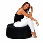 lady posing on a black outdoor bean bag ottoman by bean bags r us — thumbnail 5