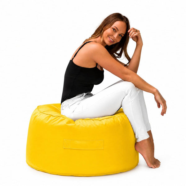 lady posing on a yellow outdoor bean bag ottoman by bean bags r us — image 3